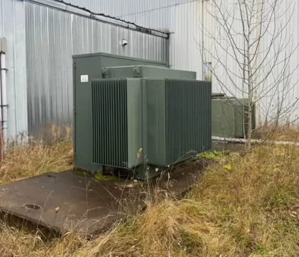 Green pad-mounted transformer prepared in an outdoor equipment yard